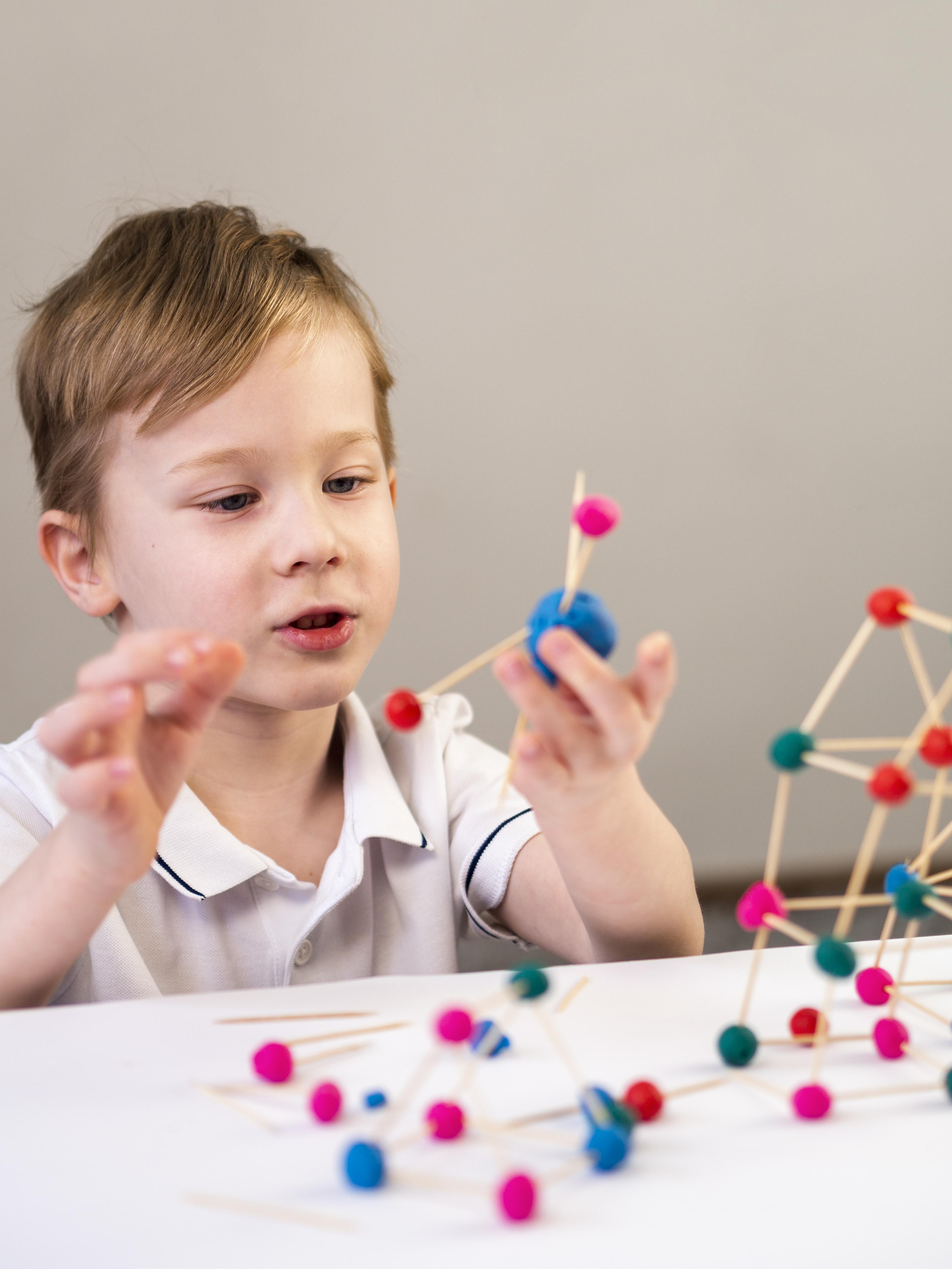 Child sorting shapes from a Whirl STEM activity kit